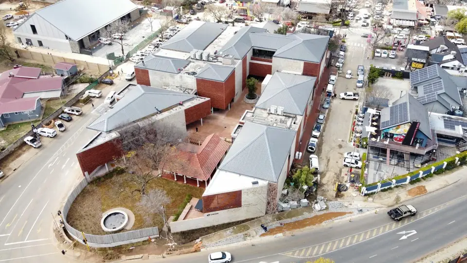 Aerial view of Bendehuis: red-brick blocks, grey roofs and landscaped courtyard