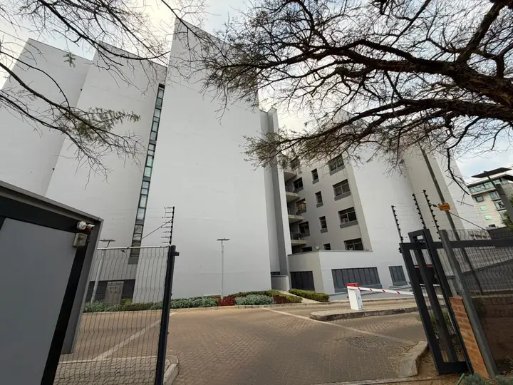 Corobay Corner blocks framed by trees at the security gate