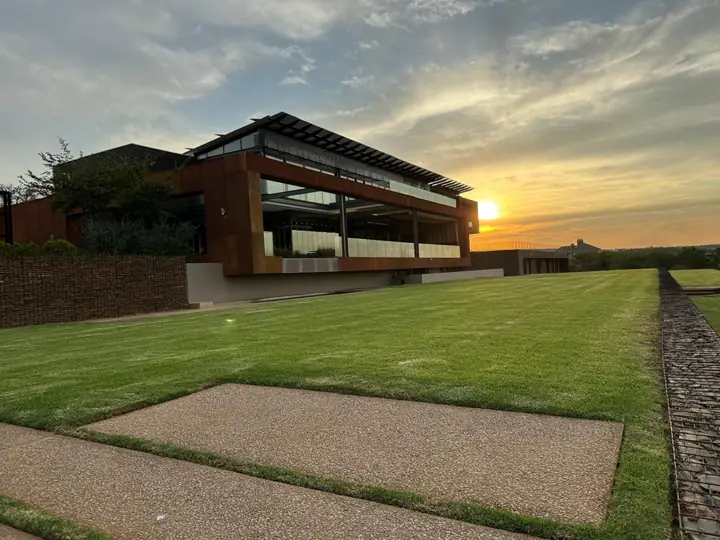 The Mooikloof residence across the lawn at golden hour