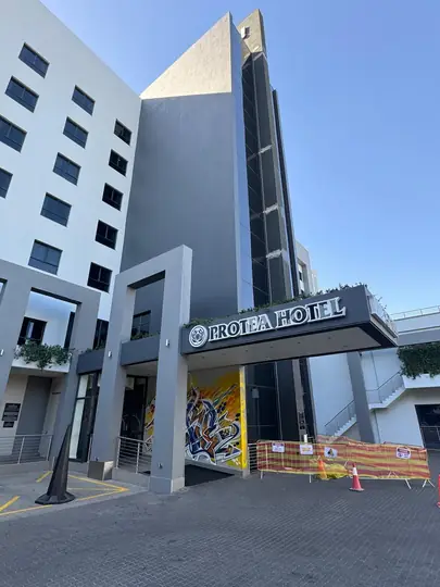 Hotel tower above the Protea Hotel entrance, site barriers still up